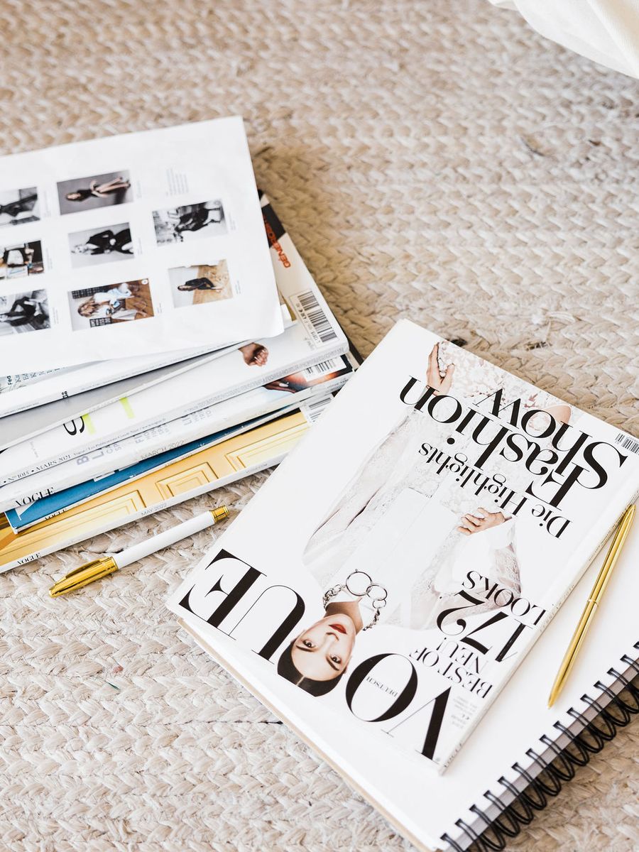 Magazines and a notebook open during competitor research